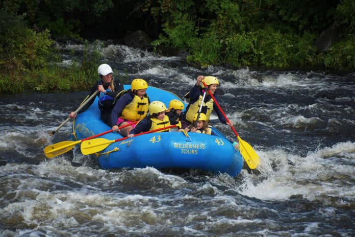 whitewater-river-guiding-kit-0-wilderness-tours-c Brenna Kelly guides a whitewater river rafting trip with Wilderness Tours