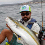 Stickbaits For Yellowtail: Learn How Now Howie Strech holds up a yellowtail caught by stickbait from a kayak