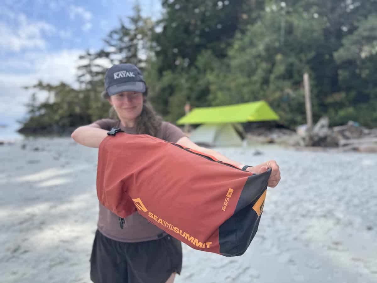 woman digging into a dry bag 