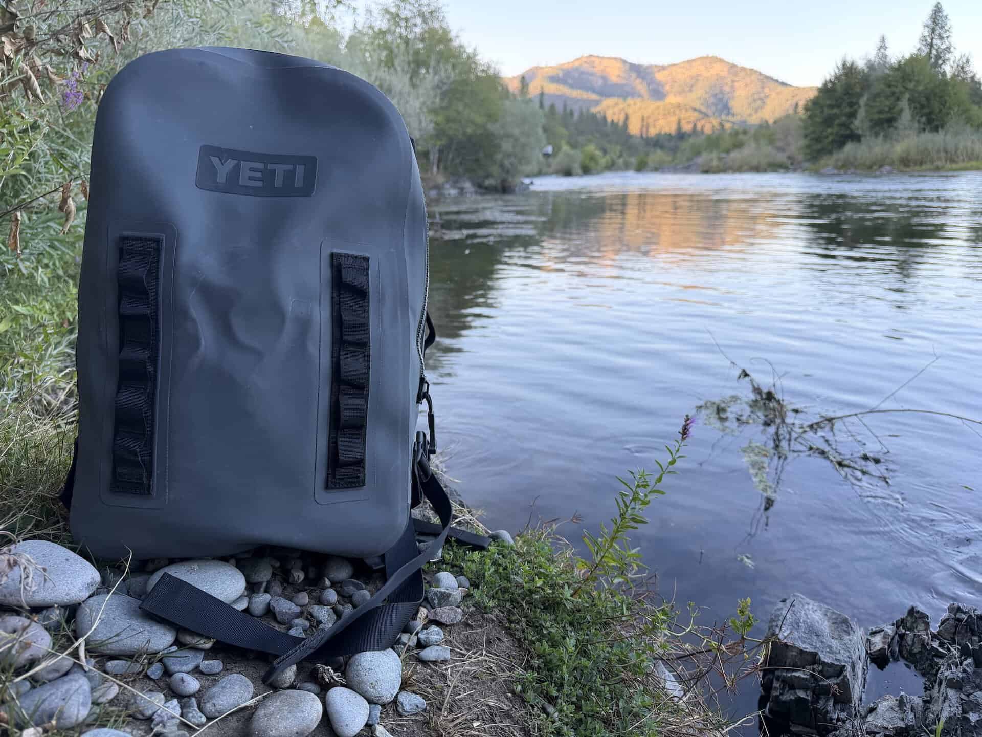 Yeti Panga dry bag on shore at a lake 