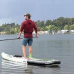 Best SUP Paddles For 2026 Man on paddleboard with standup paddleboard paddle.