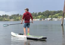 Best SUP Paddles For 2026 Man on paddleboard with standup paddleboard paddle.