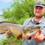 Minnesota Kayak Fisherman Breaks His Own State Bowfin Record Man with bowfin fish