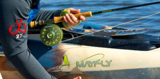 The Four Stages Of Kayak Fishing Mastery Explained person catches a fish from a kayak