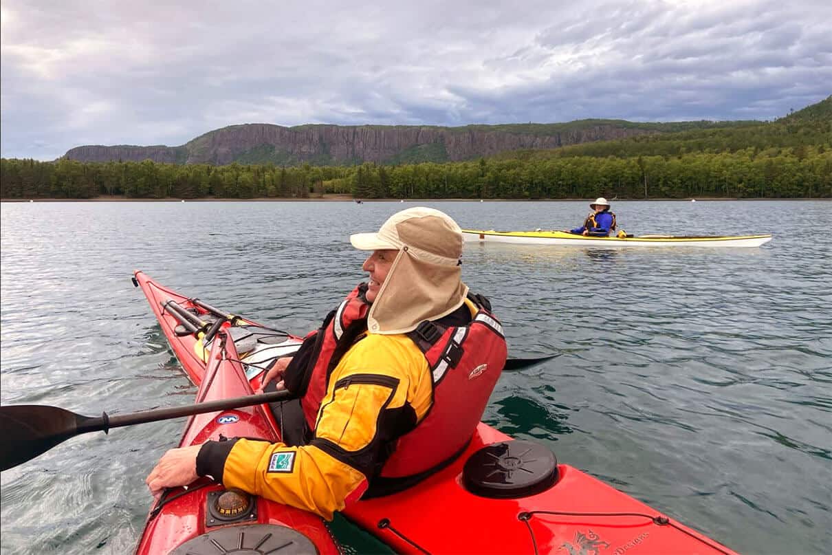 Sea kayakers on Lake Superior with Sleeping Giant Provincial Park in the background