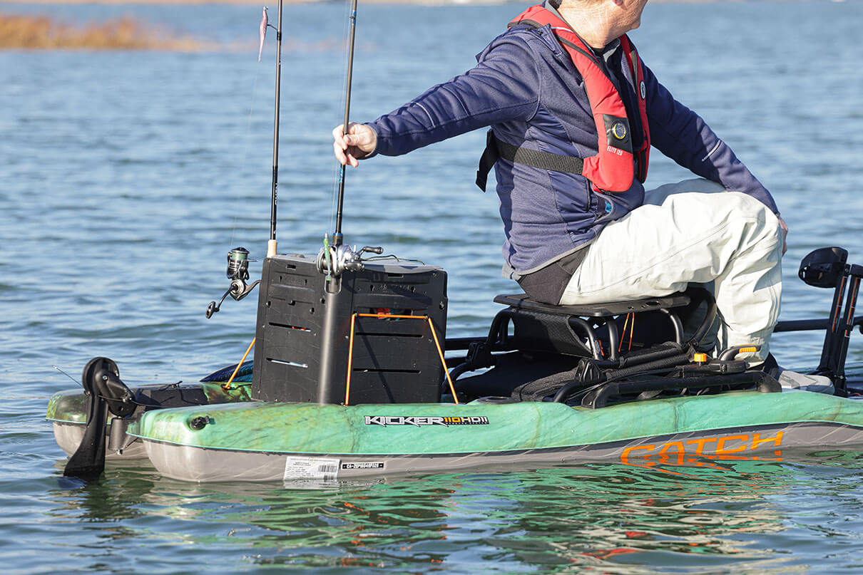 Ric Burnley reaches behind his seat for a fishing rod